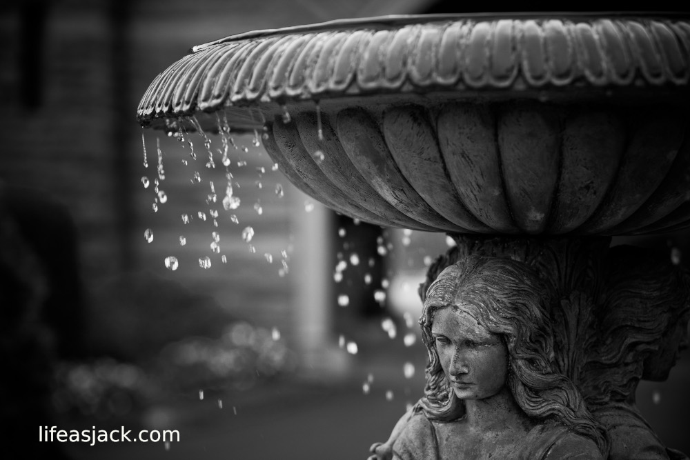 water dripping from a fountain supported by female figurines.